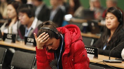 Delegates attend the closing session of the 19th conference of the United Nations Framework Convention on Climate Change in Warsaw, Poland, on Friday, Nov. 22, 2013. The talks intended to lay foundations for the new climate deal in 2015 were scheduled to end Friday, but it became apparent during the day that the fine tuning would go well into Saturday. 